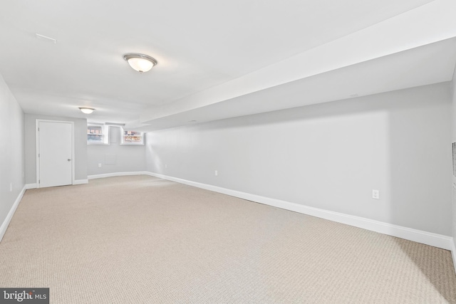 basement featuring light colored carpet