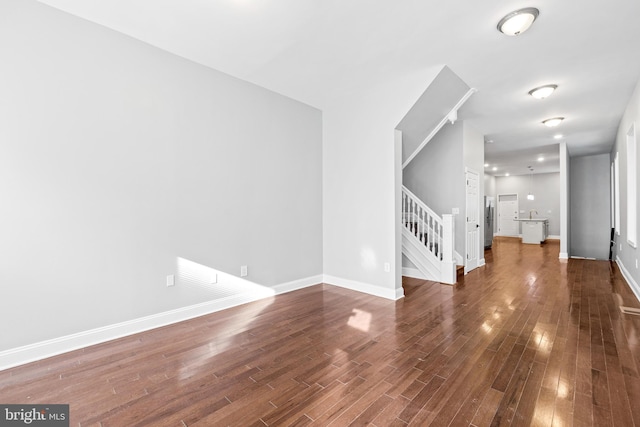 unfurnished living room with dark hardwood / wood-style floors