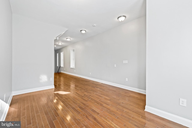 unfurnished room with hardwood / wood-style floors