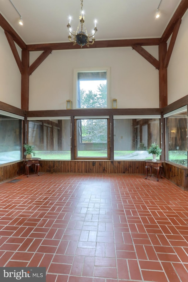 interior space with rail lighting and an inviting chandelier