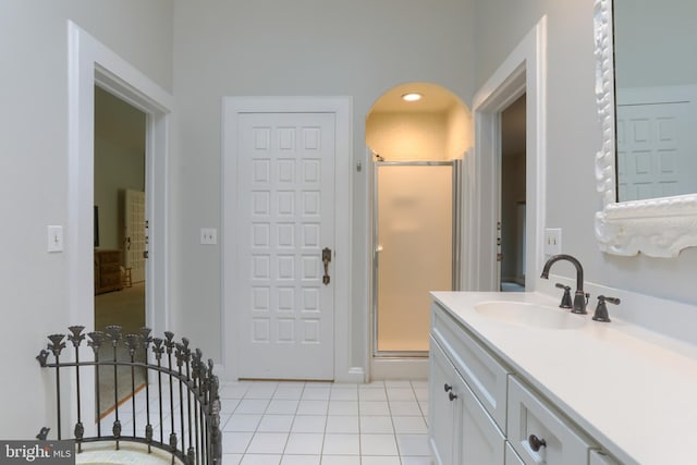 bathroom featuring vanity, a shower with door, and tile patterned floors