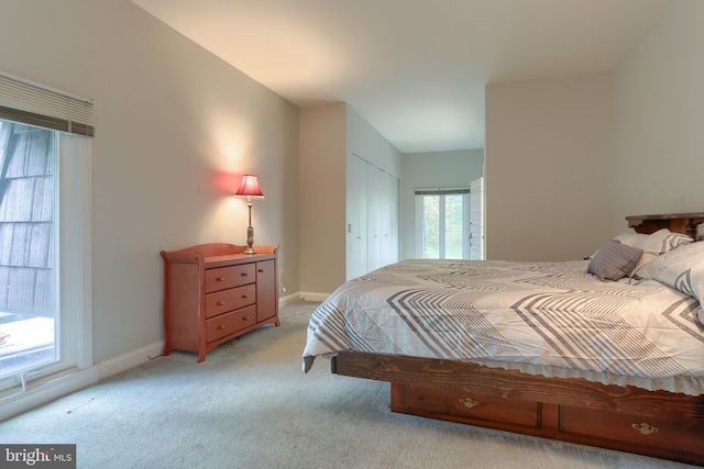 carpeted bedroom with multiple windows