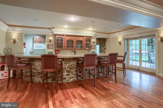 interior space featuring ornamental molding and light wood-type flooring