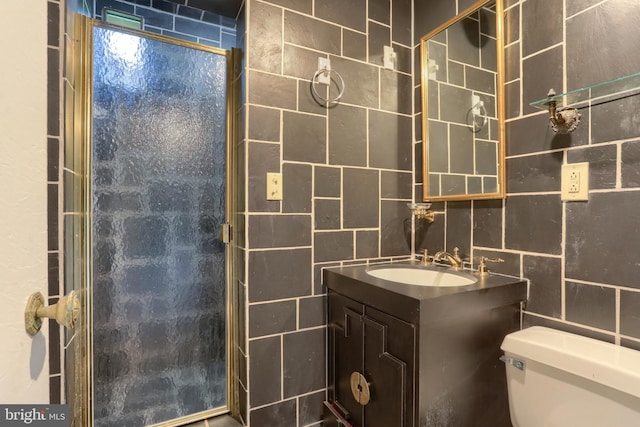 bathroom featuring tile walls, vanity, and toilet