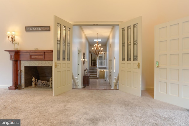 hall with a notable chandelier and carpet