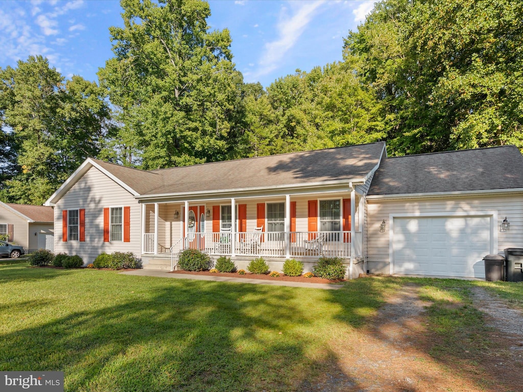 single story home featuring a porch, a front lawn, and a garage