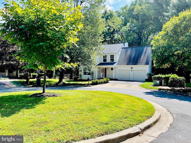 view of front of house featuring a garage and a front lawn