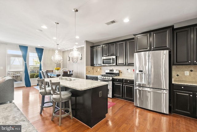 41930 Cushendall Ter, Aldie, VA 20105 - kitchen with stainless steel appliances, a sink, dark cabinets, decorative backsplash, and recessed lighting