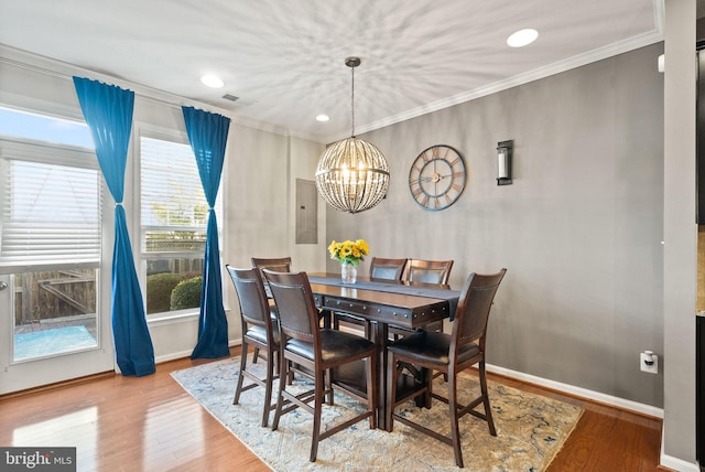 41930 Cushendall Ter, Aldie, VA 20105 - dining area featuring a chandelier, ornamental molding, wood finished floors, baseboards, and electric panel