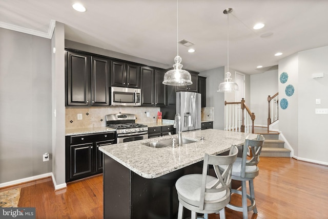 41930 Cushendall Ter, Aldie, VA 20105 - kitchen featuring appliances with stainless steel finishes, a sink, baseboards, dark cabinets, and recessed lighting