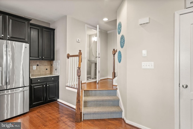 41930 Cushendall Ter, Aldie, VA 20105 - kitchen featuring freestanding refrigerator, decorative backsplash, wood finished floors, baseboards, and dark cabinets