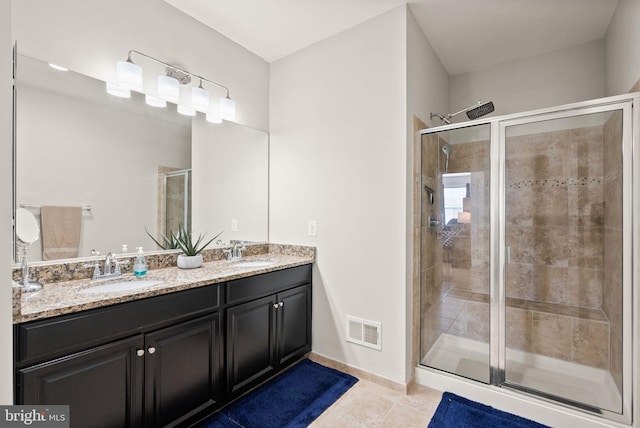 41930 Cushendall Ter, Aldie, VA 20105 - full bathroom with tile patterned floors, double vanity, a shower stall, and baseboards
