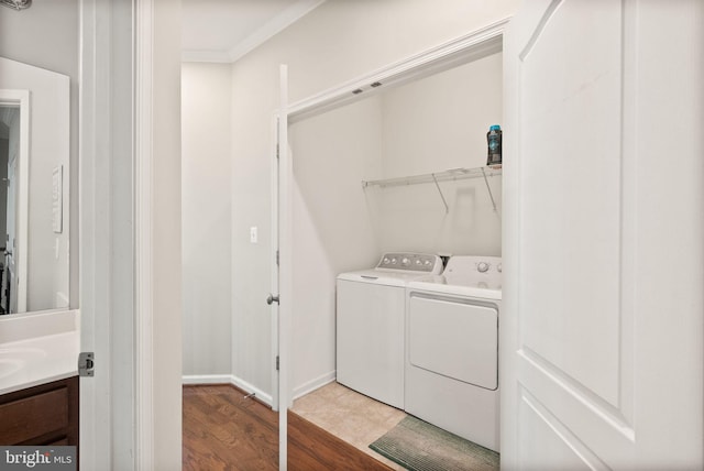 41930 Cushendall Ter, Aldie, VA 20105 - washroom with separate washer and dryer, crown molding, wood finished floors, and baseboards