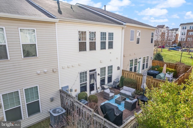 41930 Cushendall Ter, Aldie, VA 20105 - back of house featuring an outdoor living space, central air condition unit, a fenced backyard, and a patio area