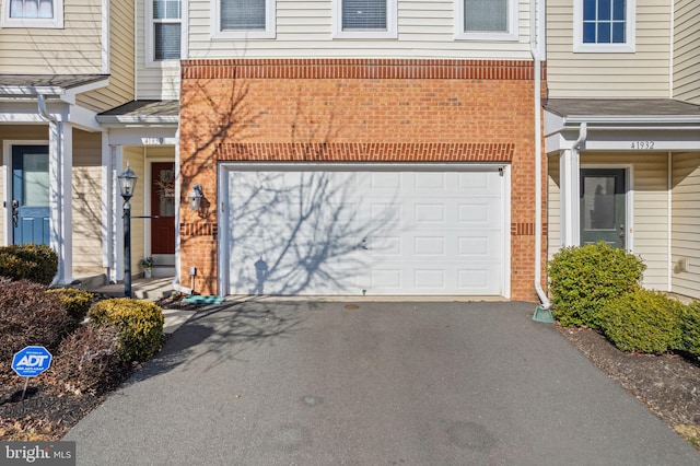 41930 Cushendall Ter, Aldie, VA 20105 - doorway to property with brick siding, a garage, and driveway