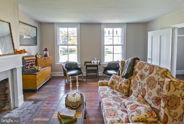 living room featuring baseboard heating and dark wood-type flooring