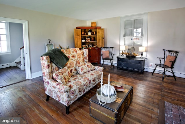 living room featuring baseboard heating and dark hardwood / wood-style flooring