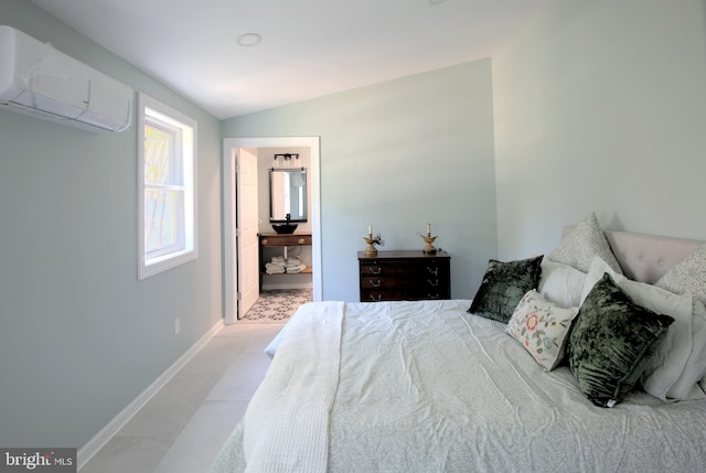 bedroom with lofted ceiling, a wall mounted AC, and ensuite bathroom