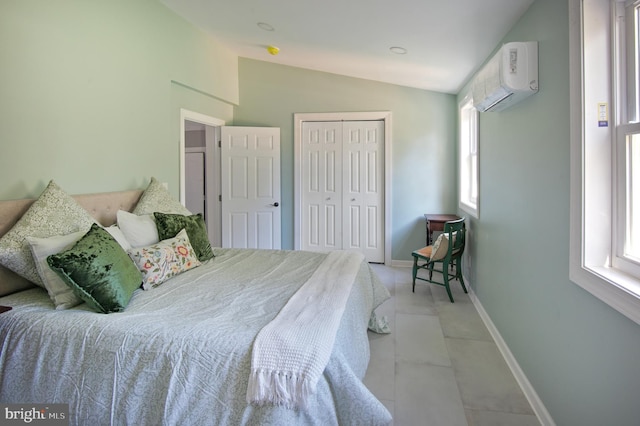 tiled bedroom featuring a closet, lofted ceiling, and a wall unit AC