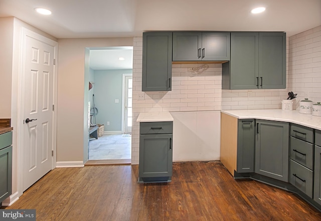 kitchen featuring gray cabinetry, backsplash, and dark hardwood / wood-style flooring