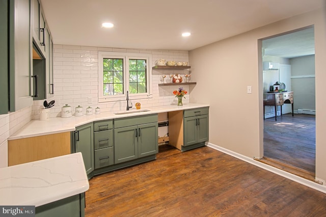 kitchen featuring a baseboard radiator, sink, dark hardwood / wood-style floors, and green cabinets