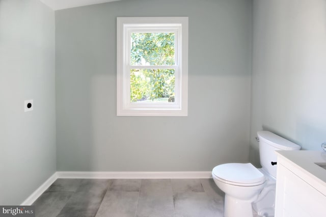 bathroom with vanity, lofted ceiling, and toilet