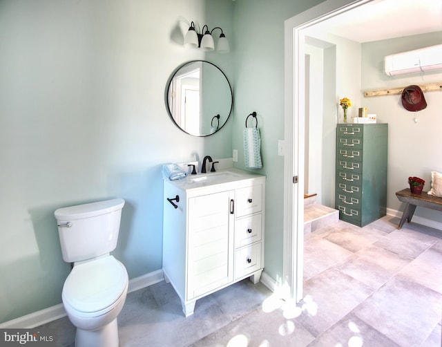 bathroom with toilet, an AC wall unit, and vanity