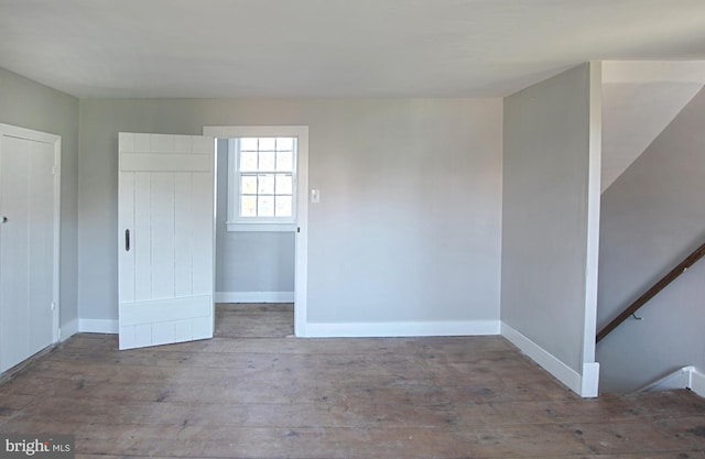 unfurnished bedroom with hardwood / wood-style floors