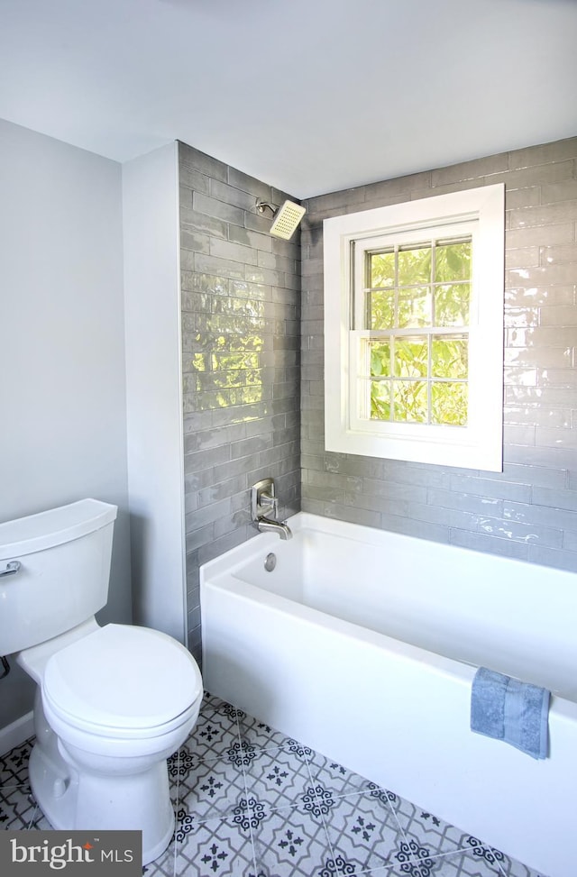 bathroom with tile patterned flooring, toilet, and shower / bath combination