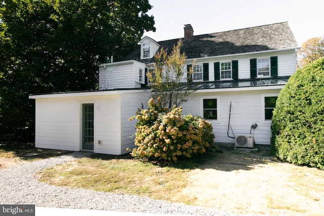 rear view of property with ac unit