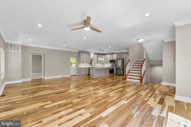 unfurnished living room with light wood-type flooring, ceiling fan, and crown molding