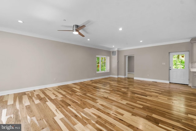 unfurnished living room with light wood-type flooring, ceiling fan, and plenty of natural light