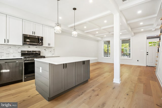 kitchen featuring white cabinetry, a center island, appliances with stainless steel finishes, gray cabinetry, and light hardwood / wood-style floors