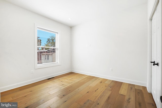 spare room featuring hardwood / wood-style floors