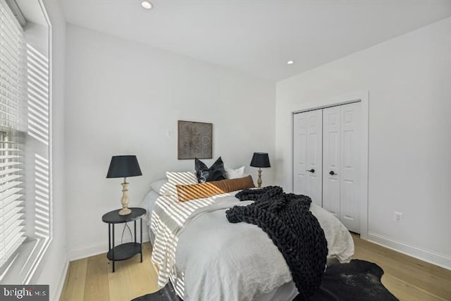 bedroom with a closet and light hardwood / wood-style floors