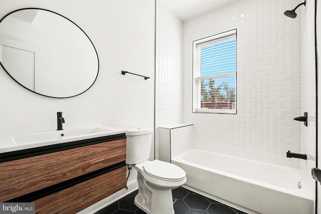 full bathroom featuring tiled shower / bath, vanity, toilet, and tile patterned flooring