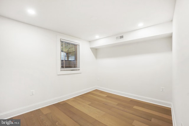 unfurnished room featuring hardwood / wood-style flooring