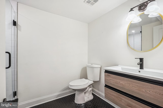 bathroom featuring vanity, toilet, tile patterned floors, and a shower with door