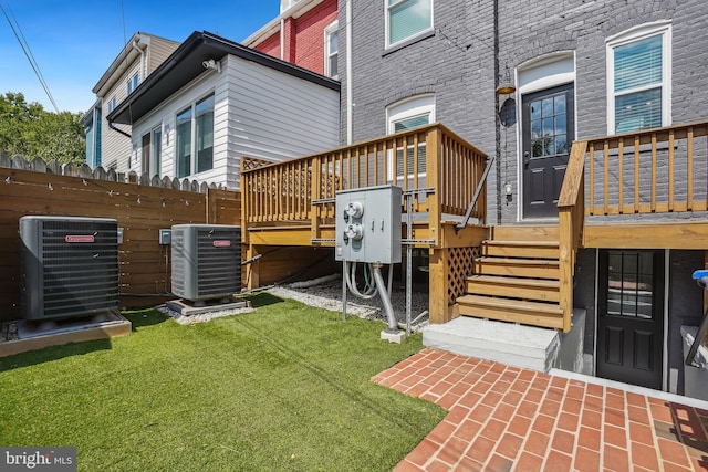 view of yard with central AC unit and a deck