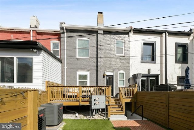 back of house featuring central AC and a deck