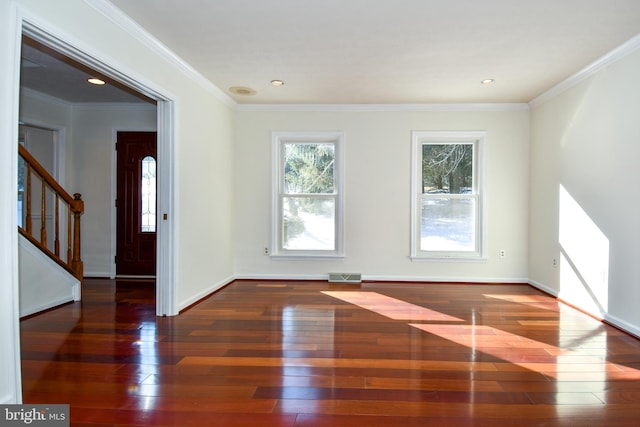 empty room featuring dark hardwood / wood-style flooring and ornamental molding