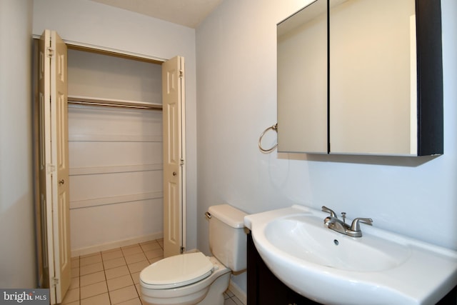 bathroom with tile patterned floors, toilet, and sink