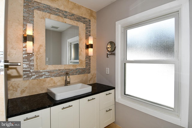 bathroom featuring decorative backsplash and vanity