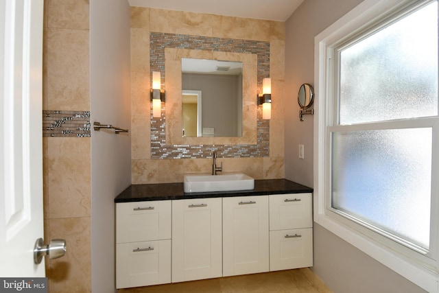 bathroom with decorative backsplash and vanity