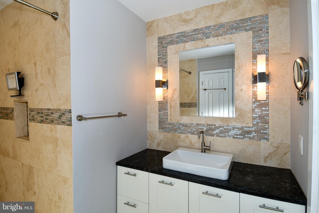 bathroom featuring tasteful backsplash and vanity