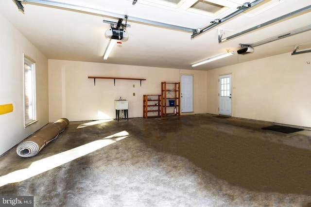 garage featuring a garage door opener and sink