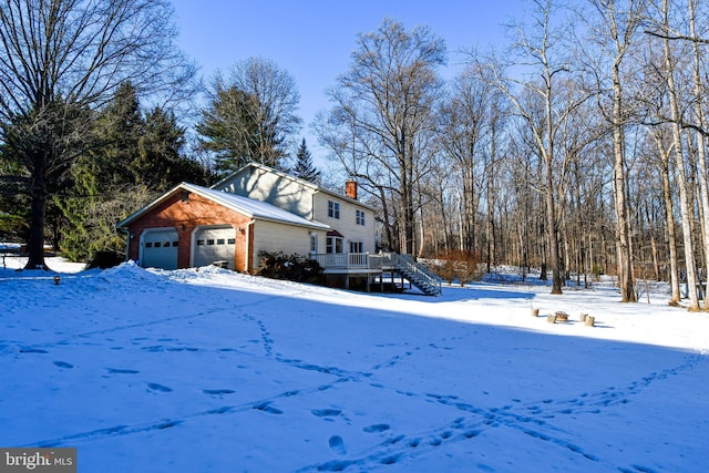 view of snowy exterior featuring a deck