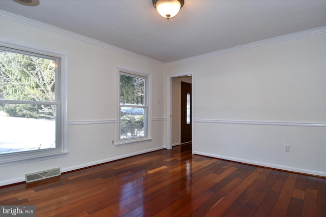 empty room with ornamental molding and dark wood-type flooring