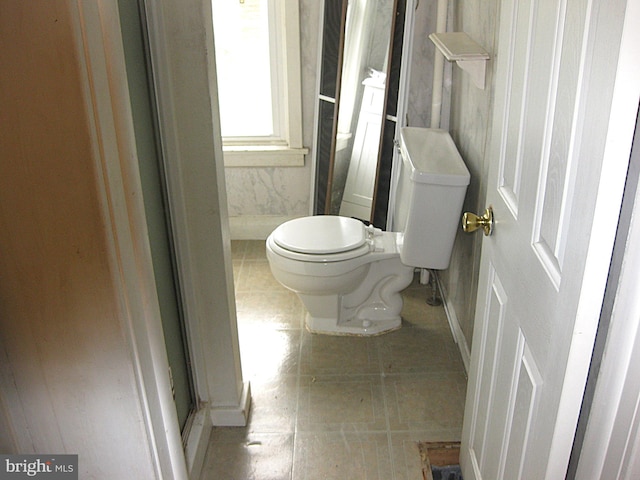 bathroom with toilet and an enclosed shower