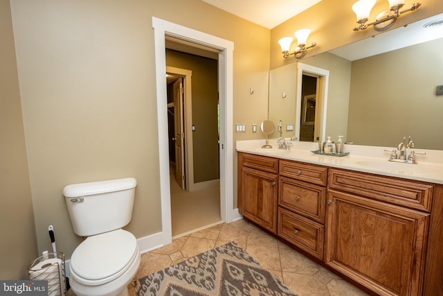 bathroom featuring tile patterned flooring, vanity, and toilet